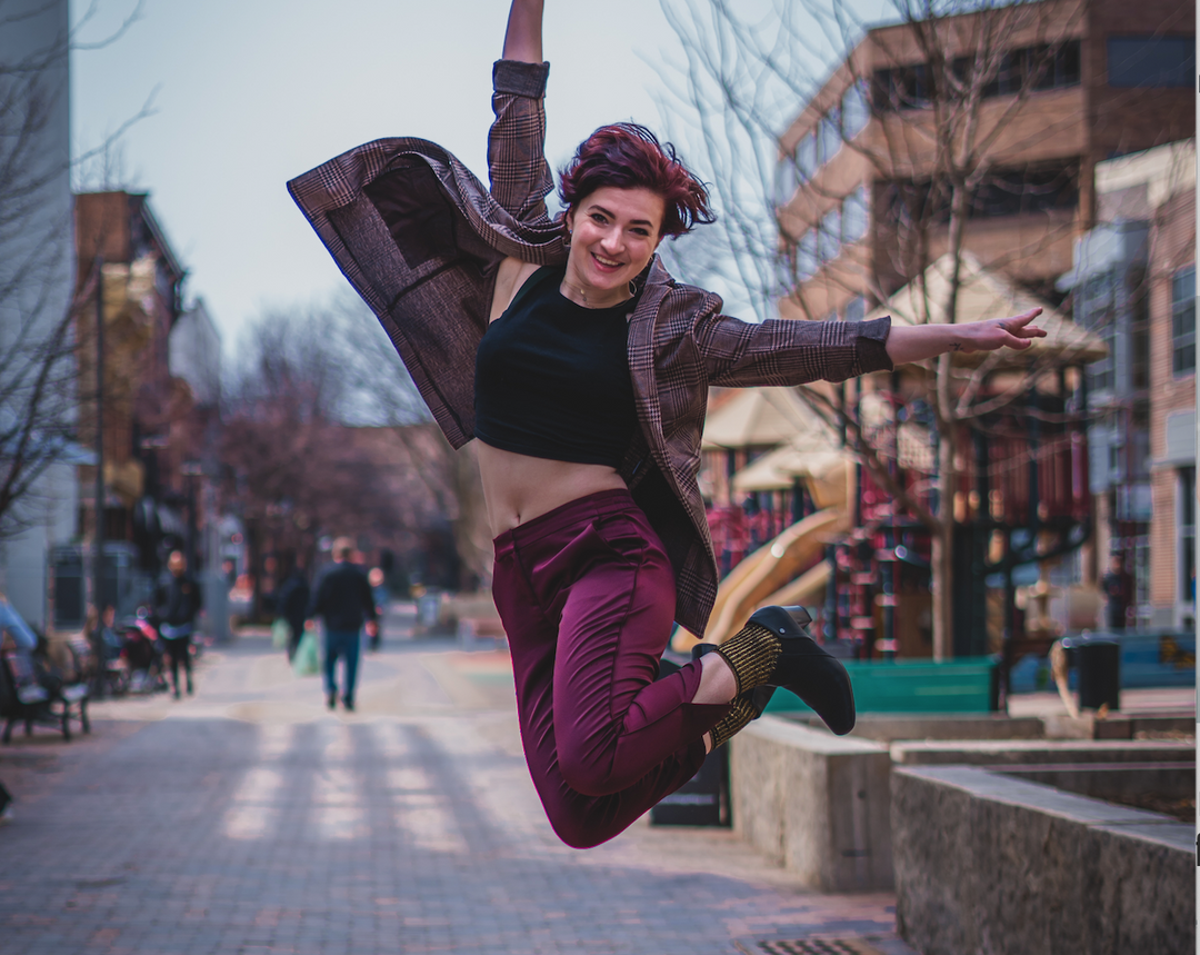 Beautiful woman jumping for joy after finding knee joint pain relief