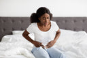 Woman suffering from stomach pain, one of collagen side effects