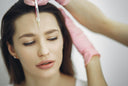 Female patient receiving cosmetic facial injection is advised to follow the proper plastic surgery recovery plan