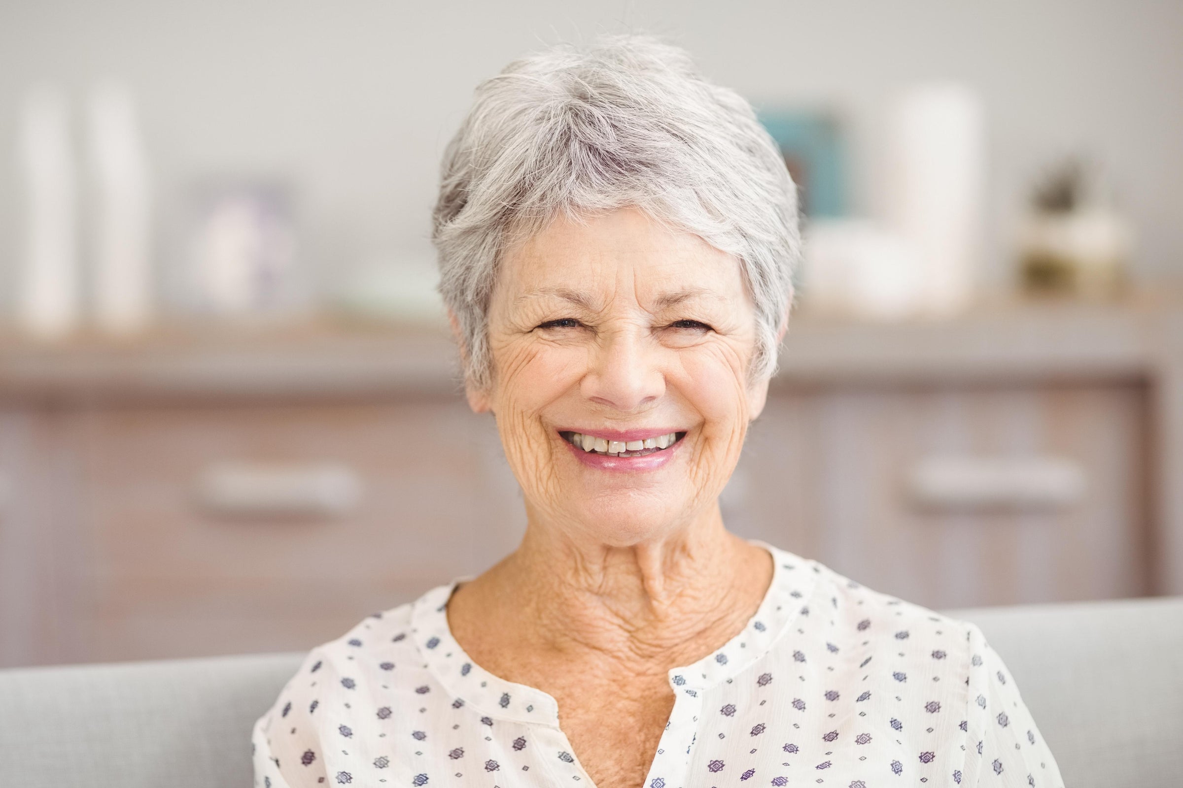 Elderly woman smiling brightly as a result of taking mood boosting supplements