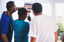 Doctors discussing the best post surgery recovery treatment for a patient while analyzing his radiology result
