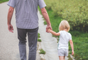 Back view of a father and young daughter walking together to buy nano hydrolyzed collagen and gut health supplements
