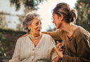 Elderly woman asking an insurance agent if collagen protein is covered by her insurance