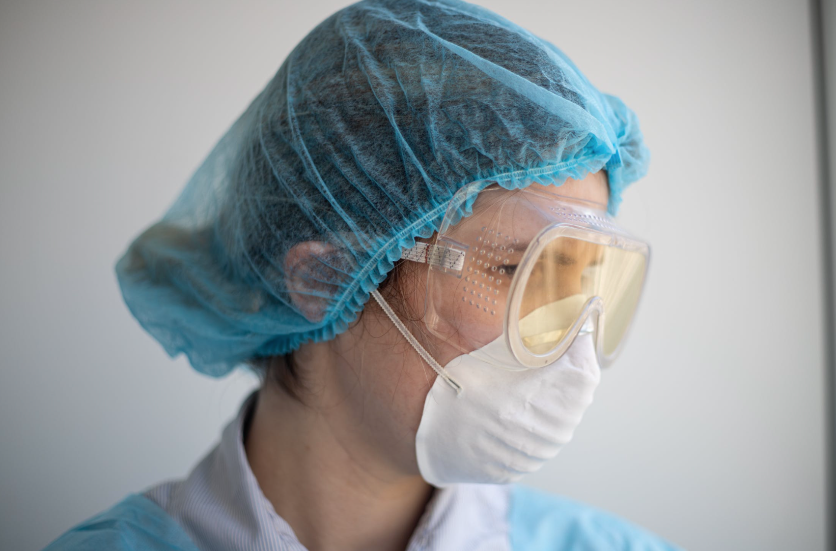 Pharmaceutical scientist who develops collagen protein is wearing personal protective equipment