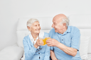 Happy senior couple toasting with medical-grade liquid collagen for bone health from ProT Gold