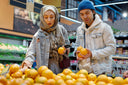 A couple in a supermarket buying foods that heal your gut
