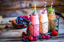 Fresh smoothies with protein powder for bariatric patients on a wooden table