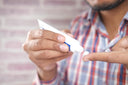 Close up of a man applying antibiotic cream—a recommended treatment for how to heal a burn fast