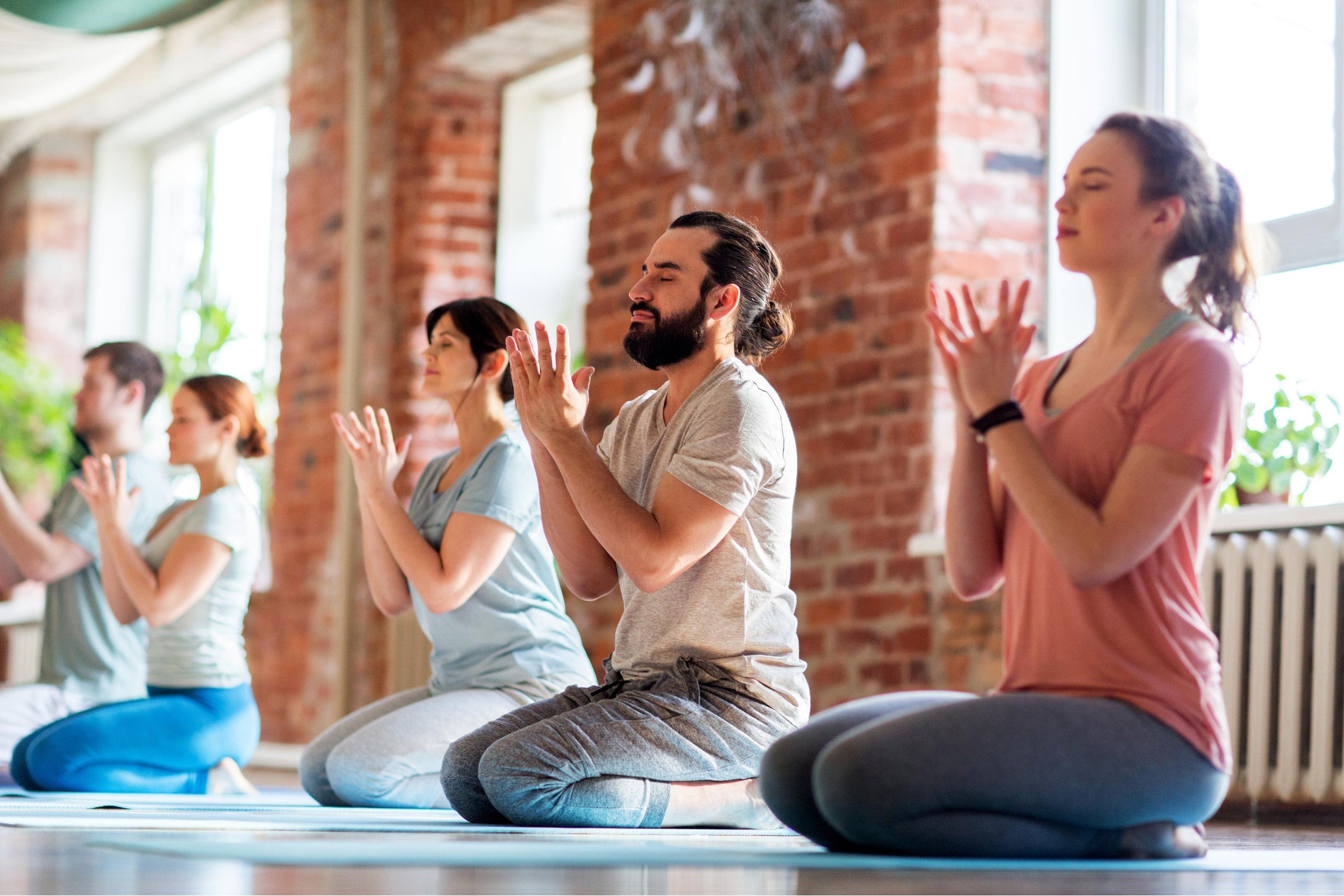 People meditating to reduce stress levels—one of the solutions to how to heal wounds faster