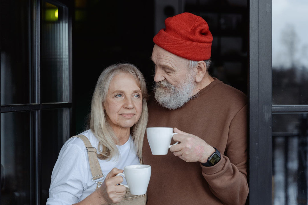 An elderly couple holding a cup of collagen for gut health