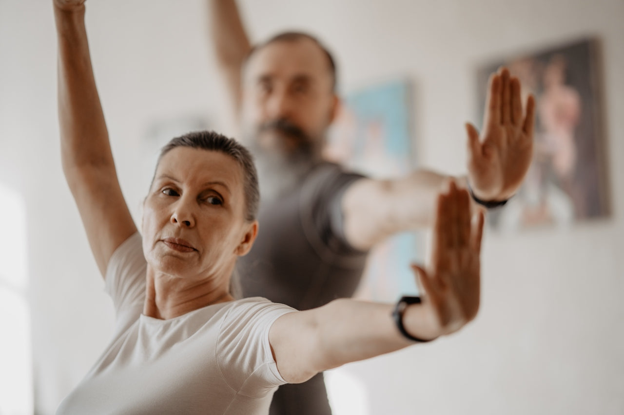 Elderly couple doing yoga to boost the production of collagen protein