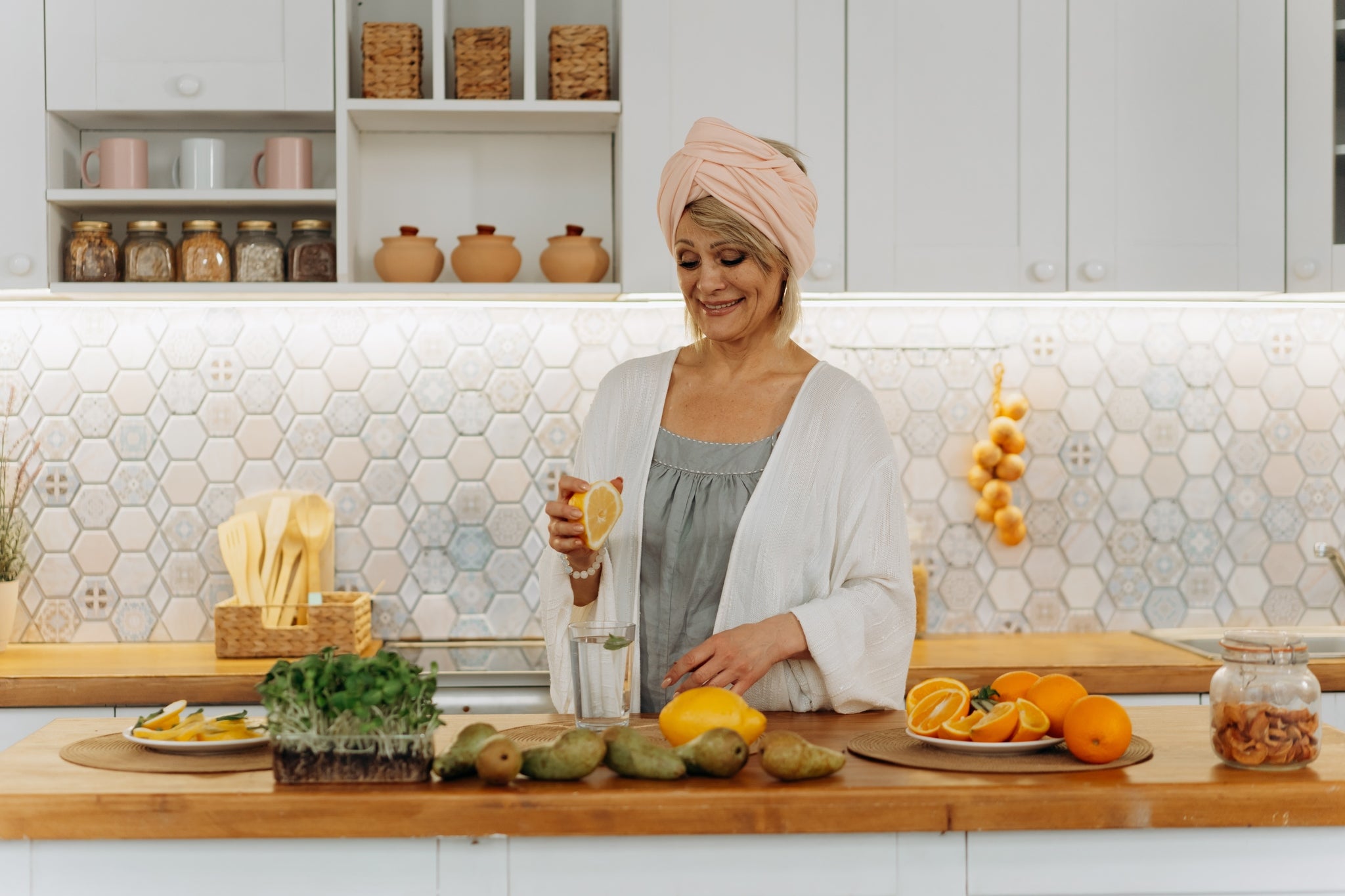 Middle-aged woman in the kitchen preparing different kinds of foods to eat for clear skin