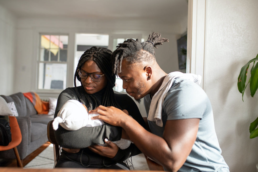 Proud couple looking at their first baby. Mom preparing for second child is wondering, “Can I take collagen while pregnant?”