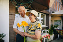 Senior woman who benefited from collagen protein while recovering from surgery receives a bouquet of flowers from her husband