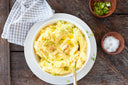 Bowl of mashed potato, a bariatric liquid diet food for patients who went through weight loss surgery, is on a wooden table