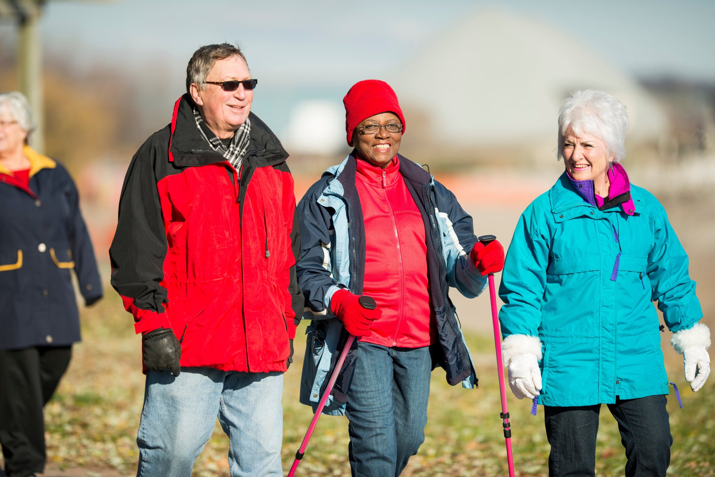 Group of healthy and happy diverse seniors out for a walk—one of the benefits of taking collagen 