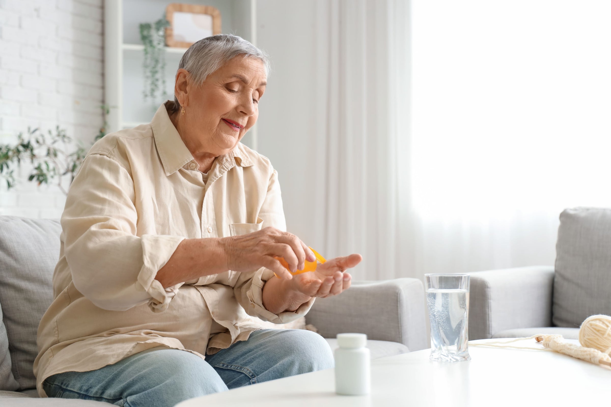 Senior woman taking the best supplements to take daily for optimum health