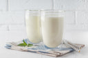 Liquid collagen peptides and hydrolyzed collagen on a white countertop