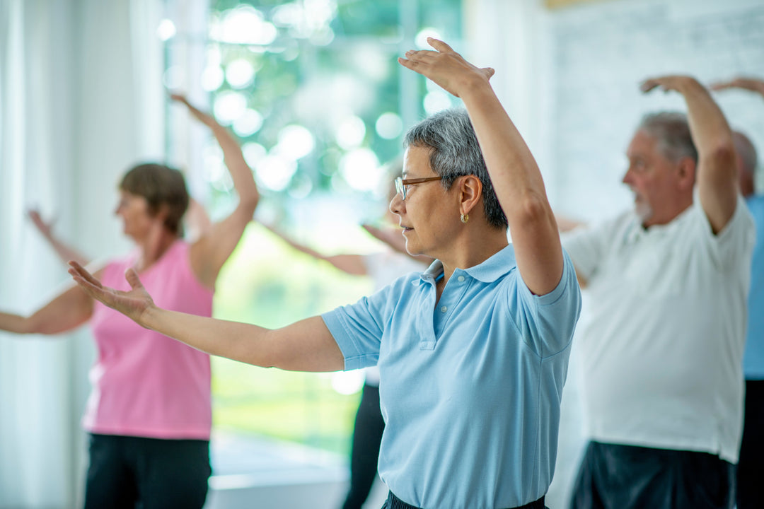 A multi-ethnic group of senior adults are practicing tai chi for hip arthritis pain relief