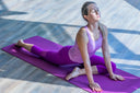Woman doing yoga for hip labral tear recovery without surgery on a purple yoga mat