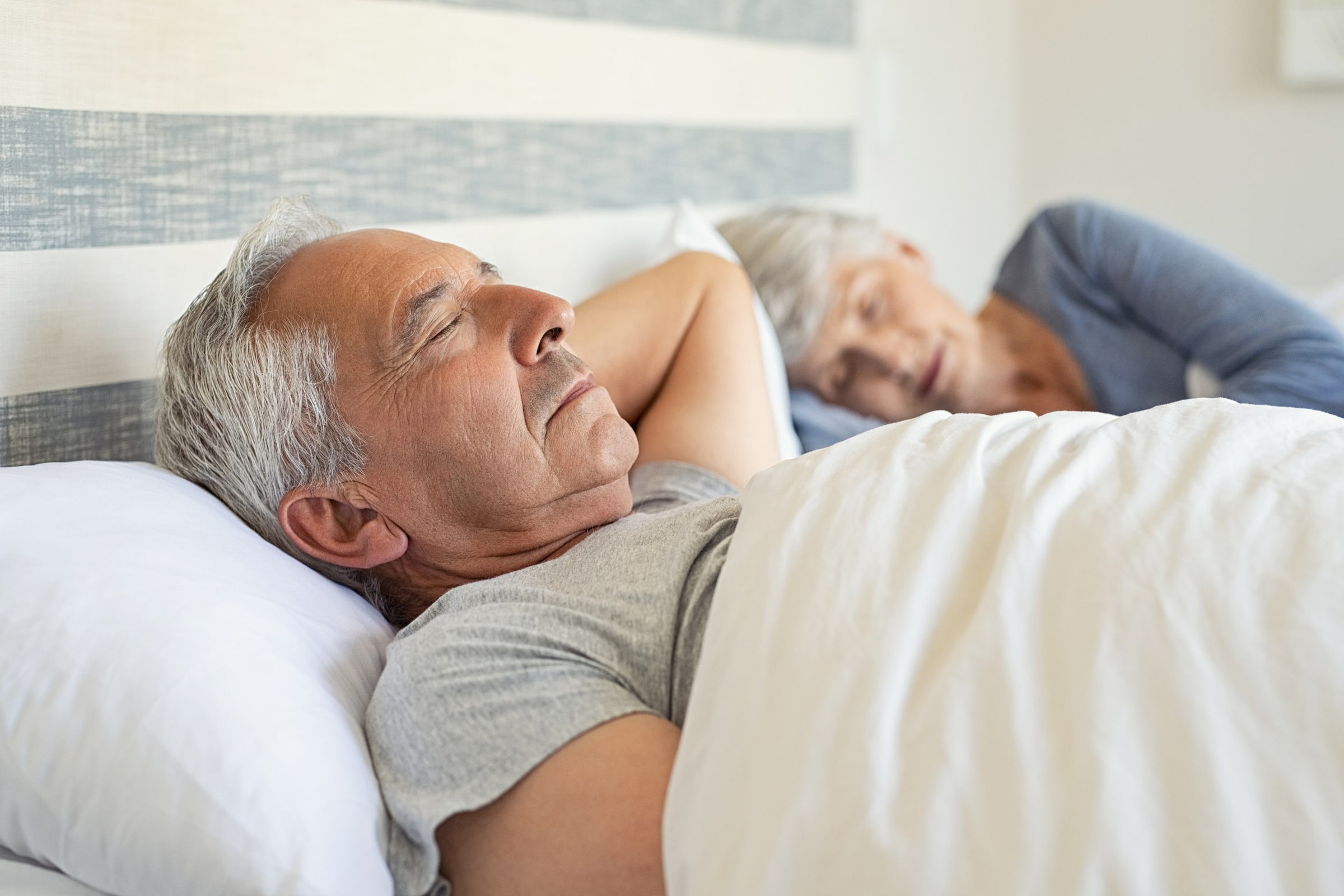 Elderly couple sleeping—one of the tips for how to make cuts heal faster