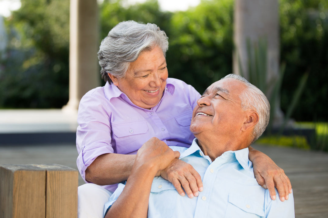 Hispanic senior couple looking at each other while talking about nutrition for wound healing