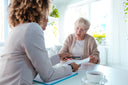 Dietitian explaining the best nutritional drinks for seniors to a senior woman