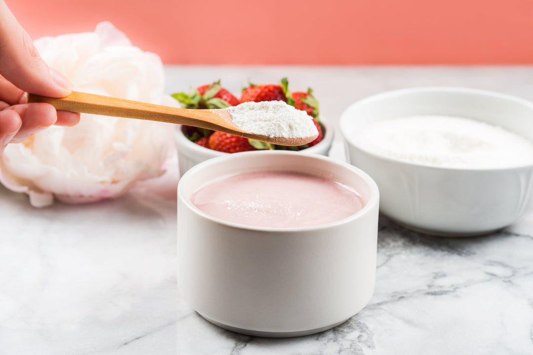 Woman adding peptides weight loss powder to her strawberry yogurt drink