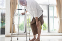 Senior woman who needs relief for knee pain is clutching her aching knee