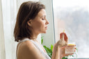 Woman taking a supplement for hip pain