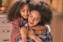 Mother embracing her daughter after taking supplements for shoulder pain 