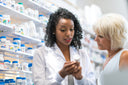 Pharmacist assisting a customer about the best vitamins for knee pain