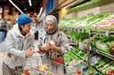 Couple with a shopping cart buying foods & supplements for broken bones healing