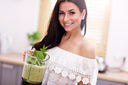 Woman holding a blender container with healthy vegetable smoothie—one of the best alternatives to protein shakes after bariatric surgery