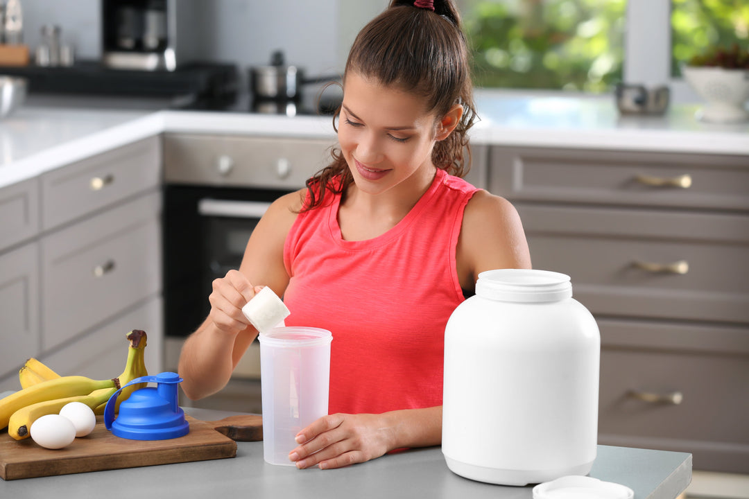 Young woman in the kitchen preparing bariatric surgery protein shakes